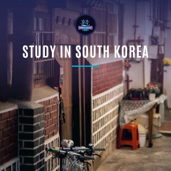 A quiet lane of traditional hanok houses in Seoul's Bukchon Hanok Village with two bicycles leaning against a brick wall, with the words Study in South Korea and the Shiksha Galore logo